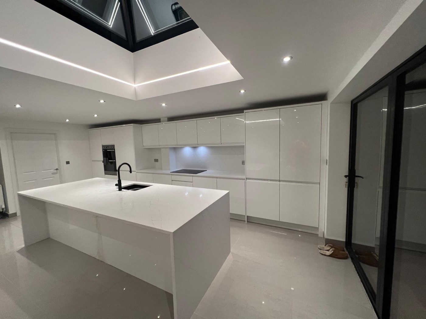 Modern white gloss kitchen with island and quartz worktops fitted by Kitchen King in Liverpool