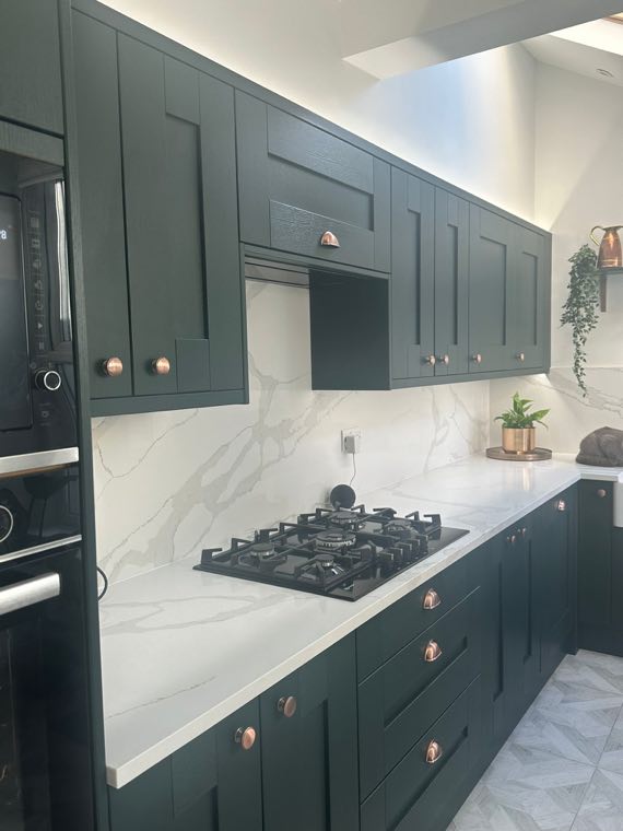 Green kitchen with copper detailing