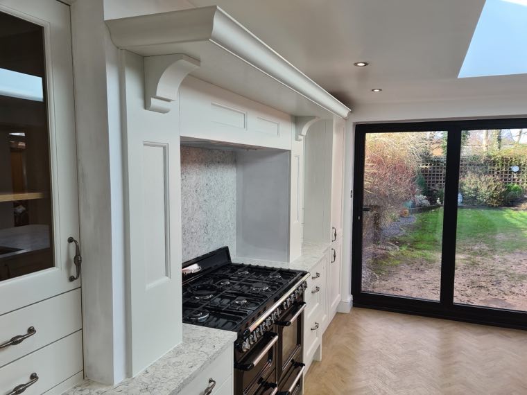 Shaker kitchen with range cooker in a bespoke alcove canopy