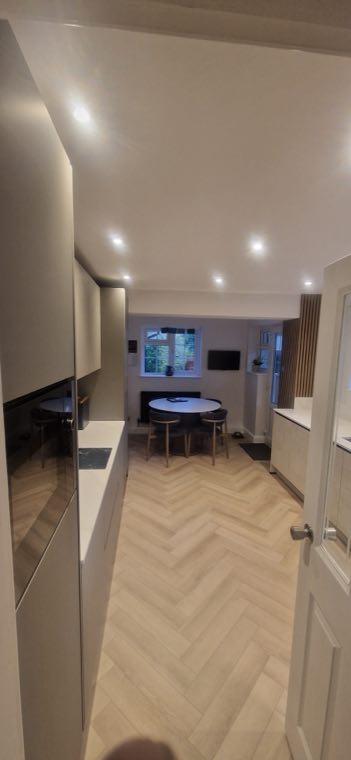 Open plan kitchen diner with herringbone flooring