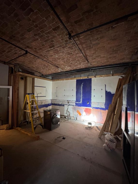The same room mid construction with exposed brick