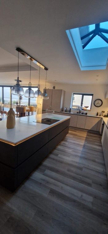Nobilia kitchen with dark island and glass pendant lighting